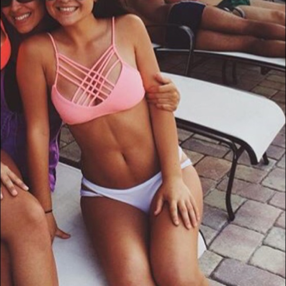 Pink bathing suit top and white bottoms